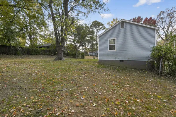 a view of a yard with large trees