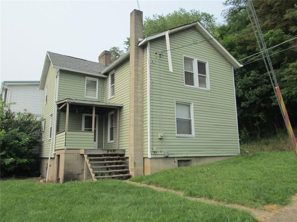 921 Johnston Avenue Kittanning, PA 16201 - Photo 1 of 9 a front view of a house with a garden