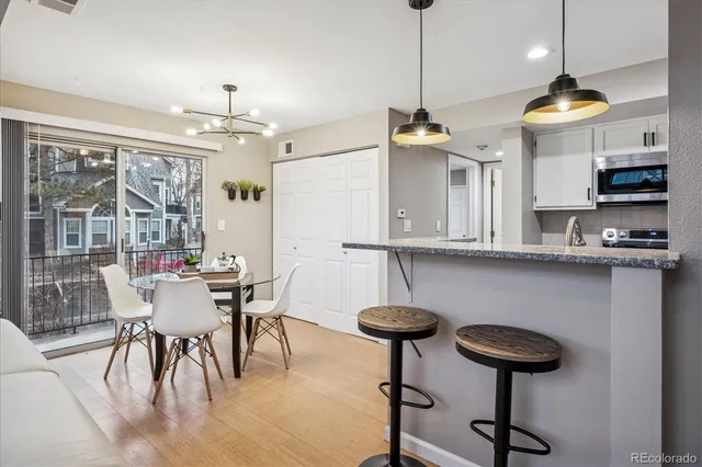 a view of a dining room with furniture wooden floor and chandelier