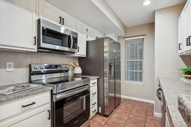 a kitchen with stainless steel appliances a stove a microwave and cabinets