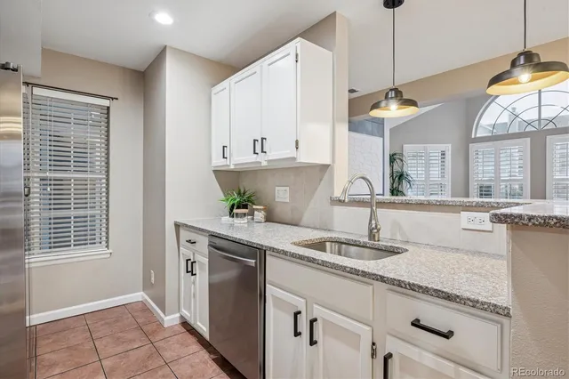 a kitchen with a sink cabinets and window