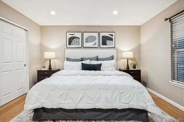 a bedroom with a bed and a night stand