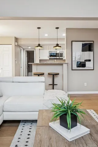 a living room with furniture and a potted plant