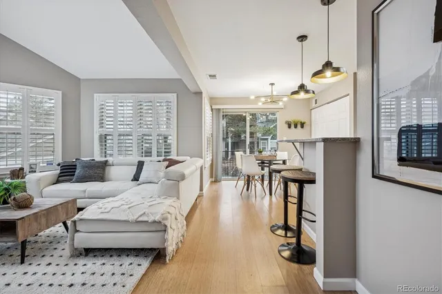 a living room with furniture and floor to ceiling windows