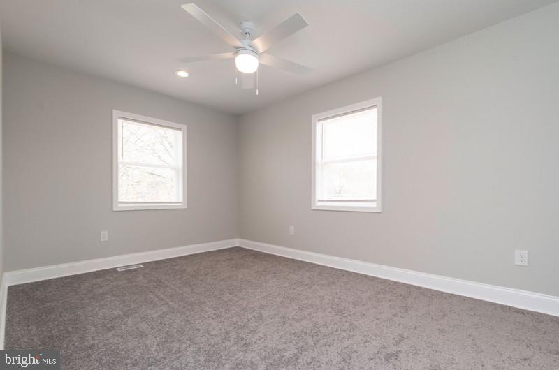 1426 East Cold Spring Lane Baltimore, MD 21239 - Photo 11 of 27 an empty room with a window and a fan