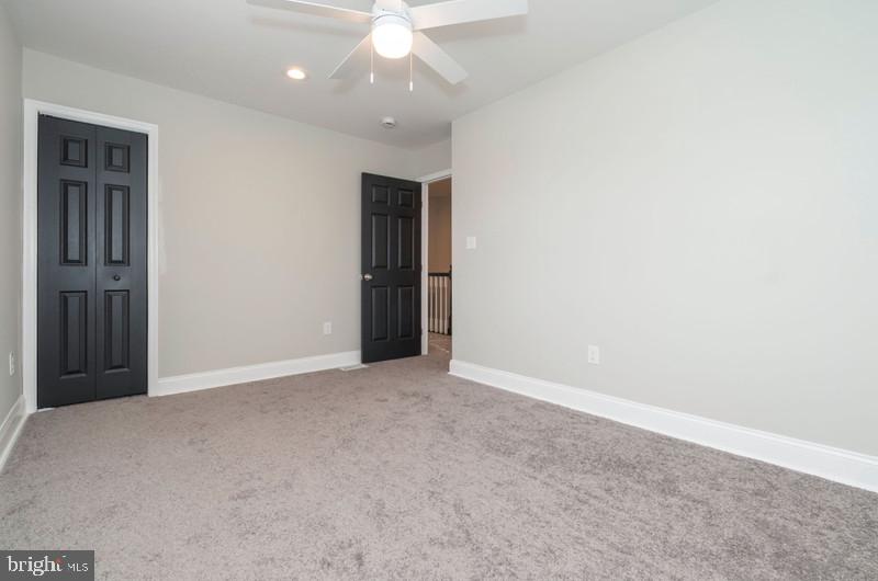 1426 East Cold Spring Lane Baltimore, MD 21239 - Photo 12 of 27 an empty room with a ceiling fan and window