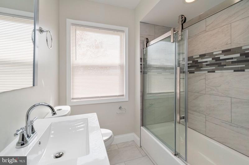 1426 East Cold Spring Lane Baltimore, MD 21239 - Photo 13 of 27 a bathroom with a sink and a shower
