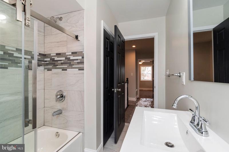 1426 East Cold Spring Lane Baltimore, MD 21239 - Photo 14 of 27 a bathroom with a tub sink and mirror