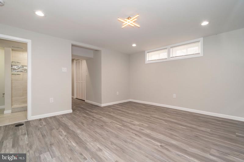 1426 East Cold Spring Lane Baltimore, MD 21239 - Photo 20 of 27 an empty room with wooden floor and windows