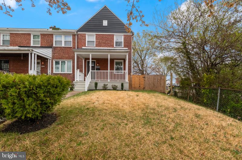 1426 East Cold Spring Lane Baltimore, MD 21239 - Photo 23 of 27 a front view of a house with a garden