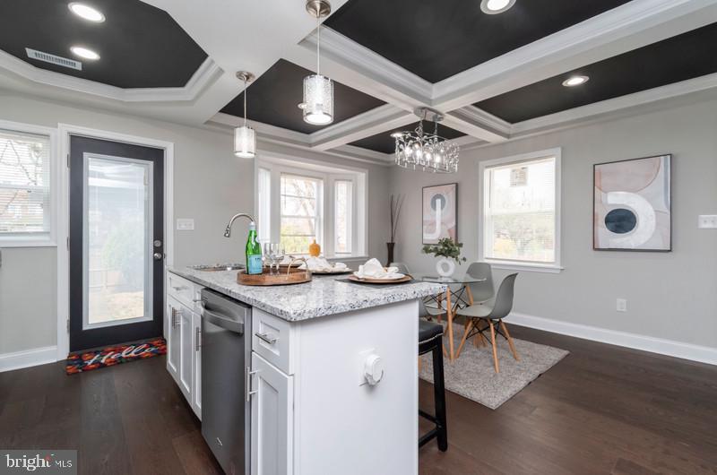 1426 East Cold Spring Lane Baltimore, MD 21239 - Photo 5 of 27 a kitchen with stainless steel appliances granite countertop a stove and a wooden floors