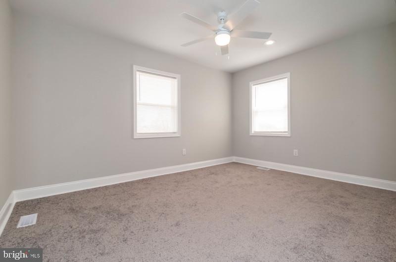 1426 East Cold Spring Lane Baltimore, MD 21239 - Photo 9 of 27 an empty room with a window and a fan