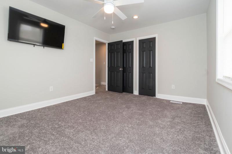 1426 East Cold Spring Lane Baltimore, MD 21239 - Photo 10 of 27 a view of a livingroom with an empty space & a flat screen tv