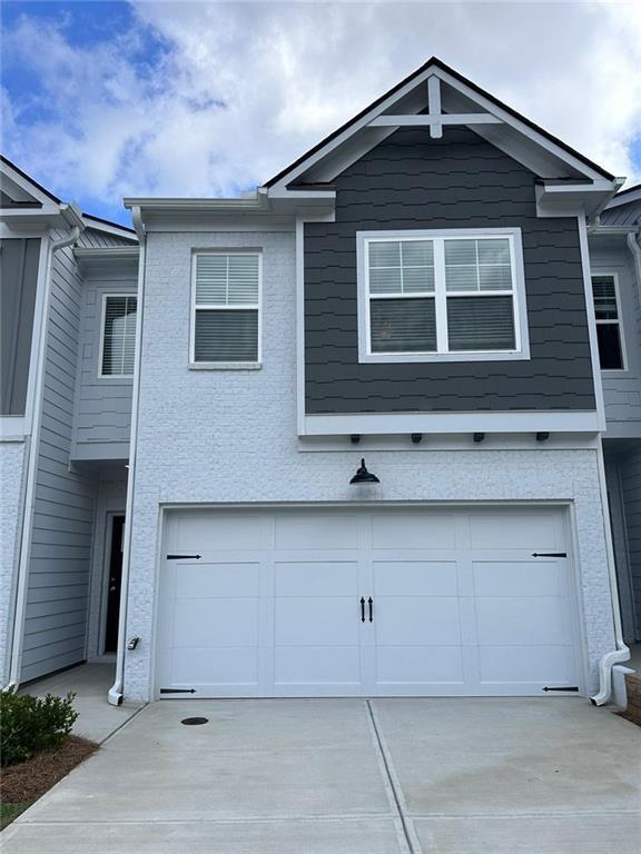 a front view of a house with garage
