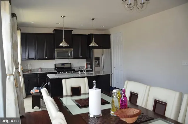 a kitchen with a table and chairs in it