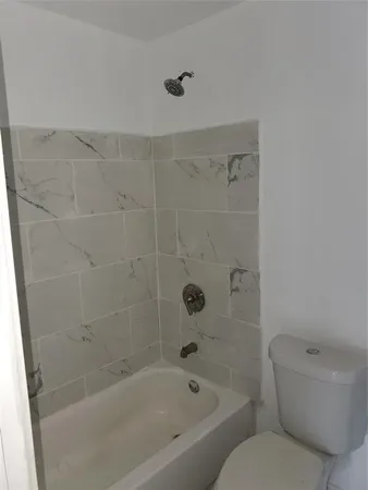 a bathroom with a bathtub and a toilet