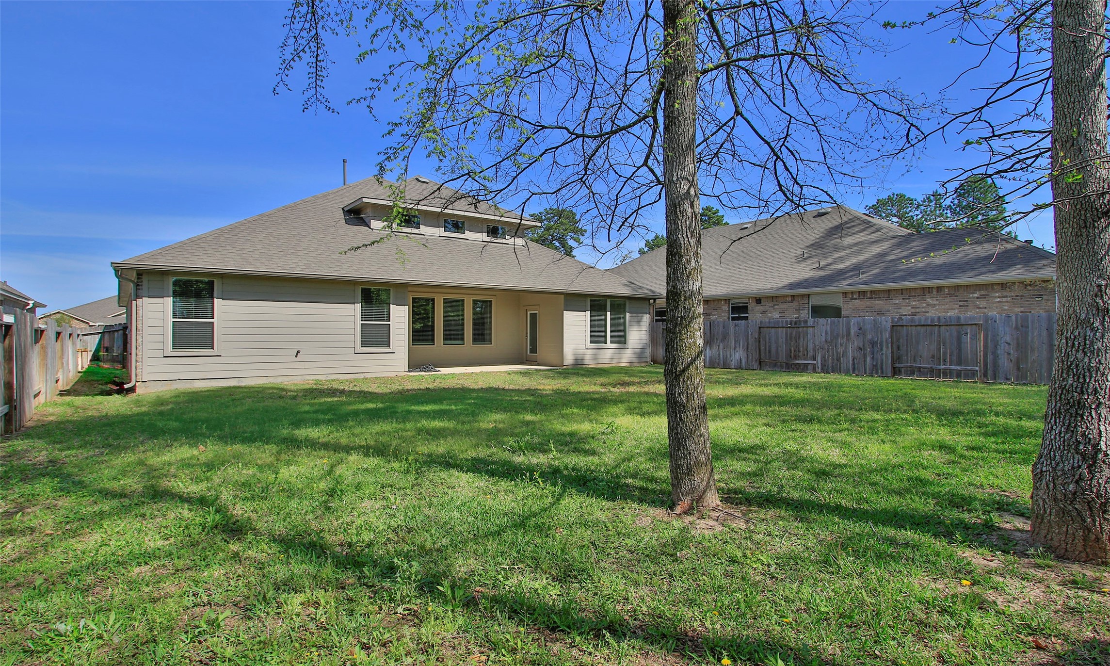 14120 Sand Ridge Court Conroe, TX 77384 - Photo 42 of 43 a backyard of a house with lots of green space