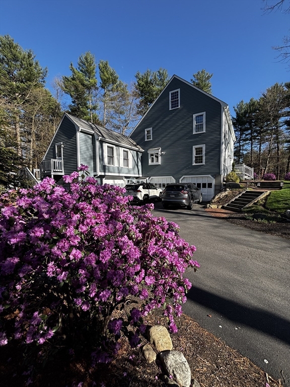 142 Baker Street Walpole, MA 02081 - Photo 4 of 42 a front view of a house with a yard