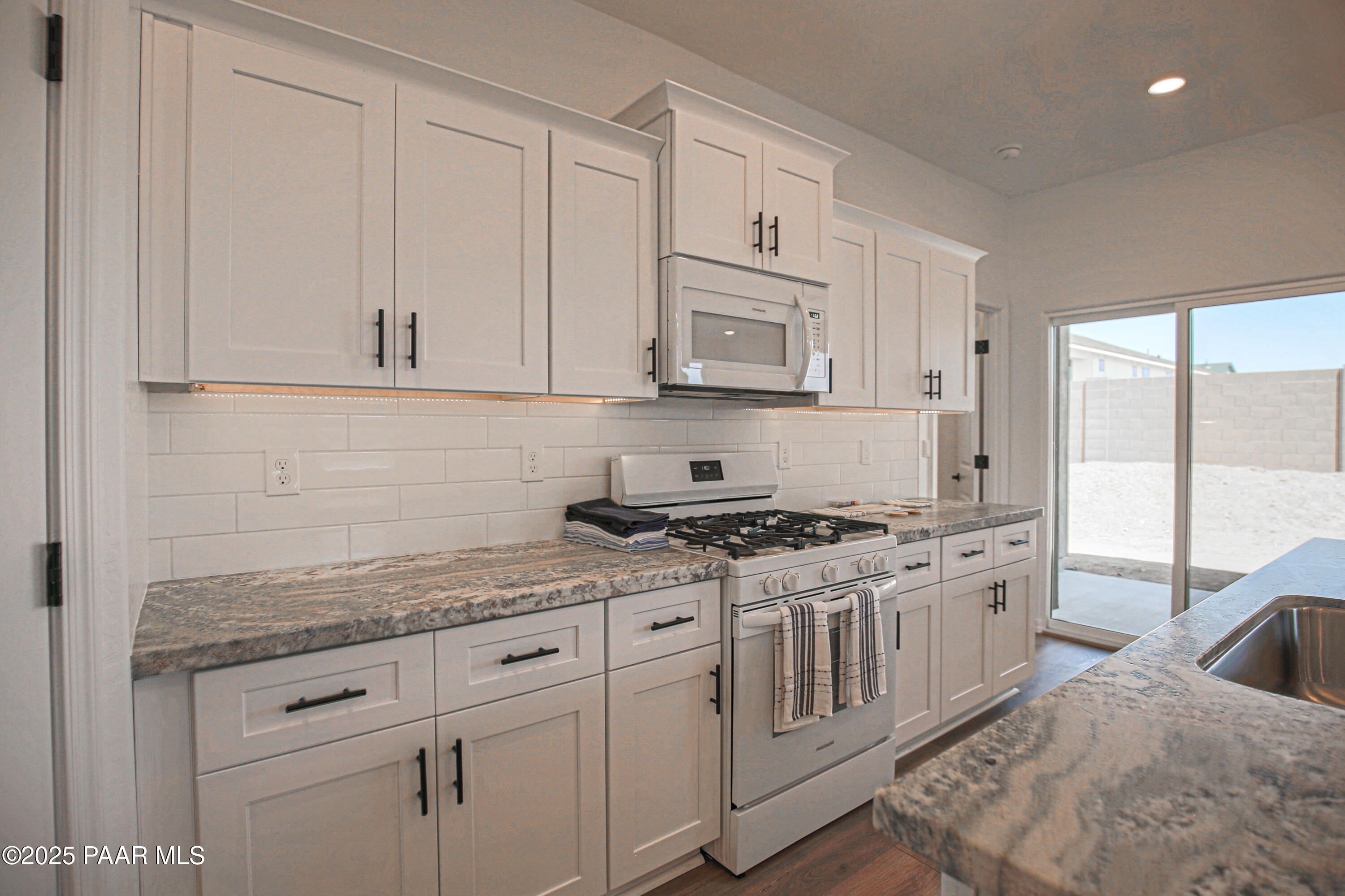 1224 Woodchute Road Prescott, AZ 86305 - Photo 11 of 43 a kitchen with stainless steel appliances granite countertop white cabinets and a granite counter tops