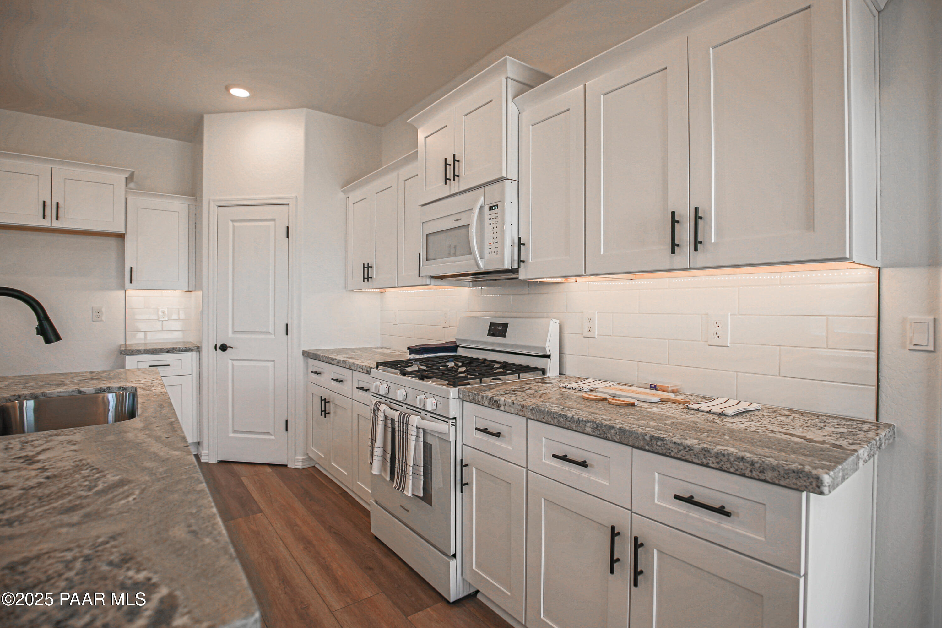 1224 Woodchute Road Prescott, AZ 86305 - Photo 12 of 43 a kitchen with stainless steel appliances granite countertop a stove a sink and a refrigerator