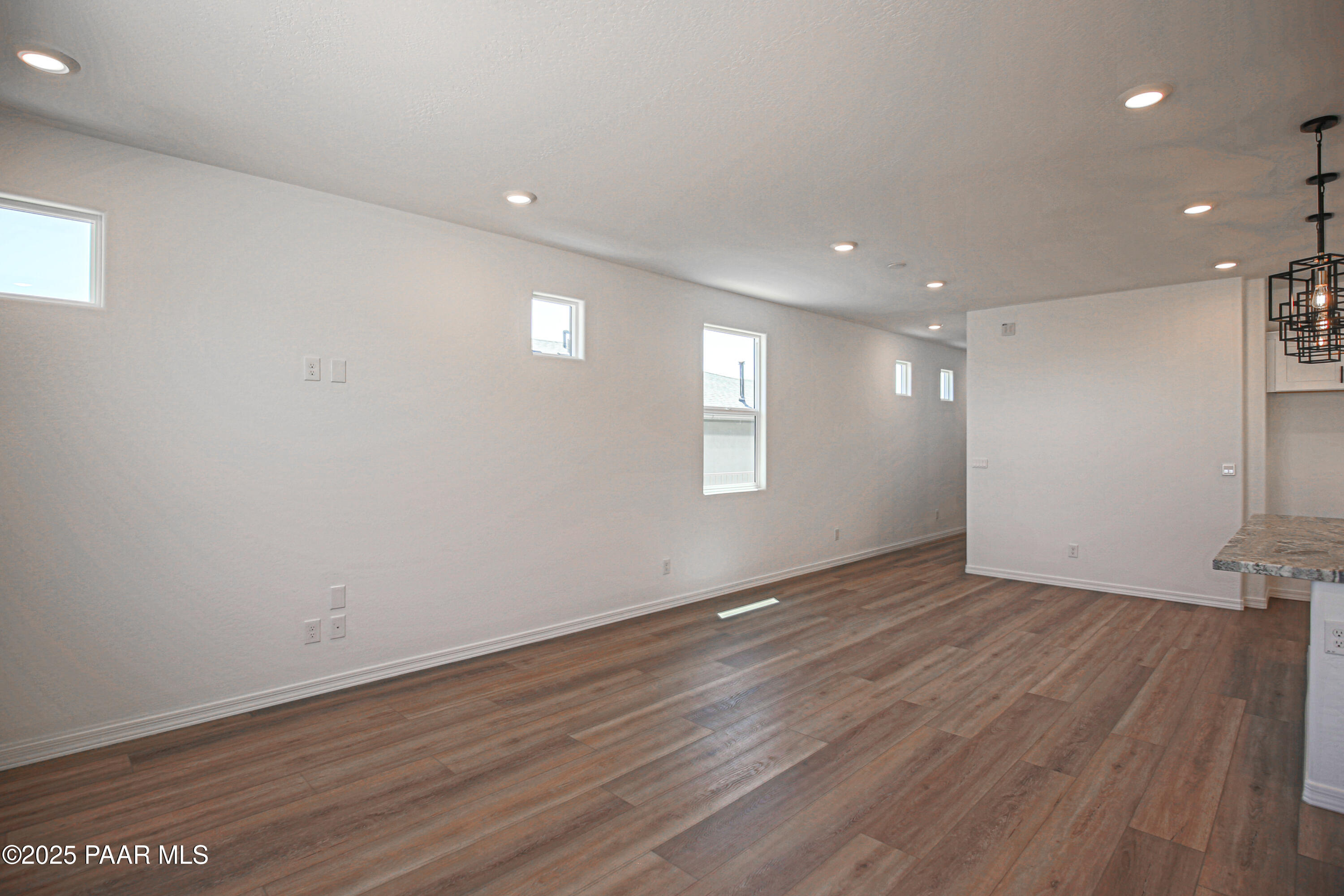 1224 Woodchute Road Prescott, AZ 86305 - Photo 13 of 43 an empty room with wooden floor and windows
