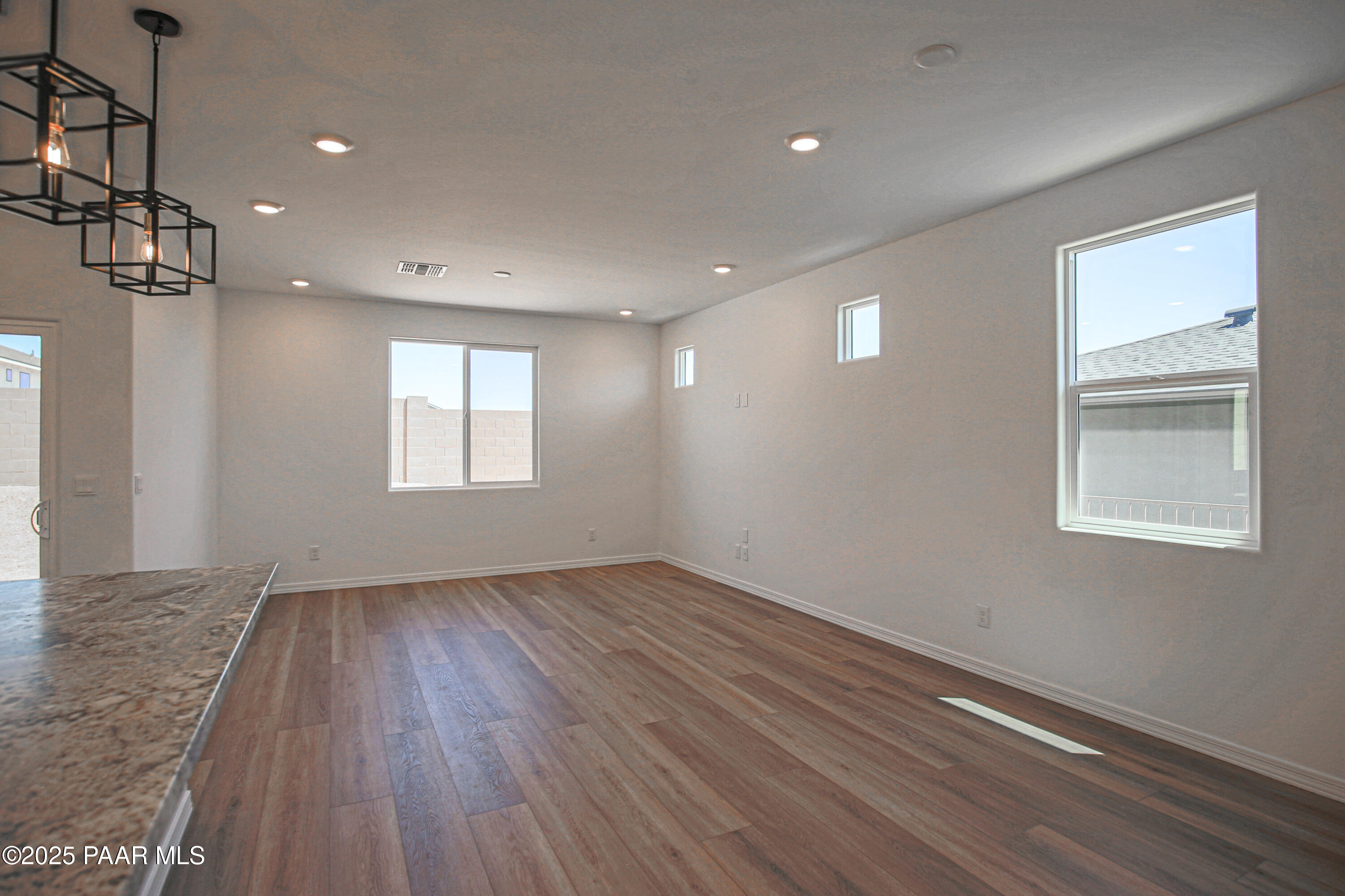 1224 Woodchute Road Prescott, AZ 86305 - Photo 14 of 43 a view of an empty room with wooden floor and a window