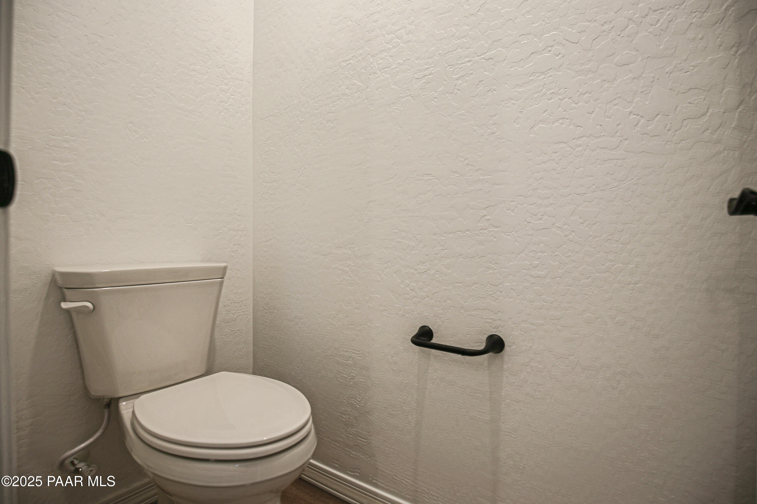 1224 Woodchute Road Prescott, AZ 86305 - Photo 22 of 43 a white toilet sitting next to a white wall