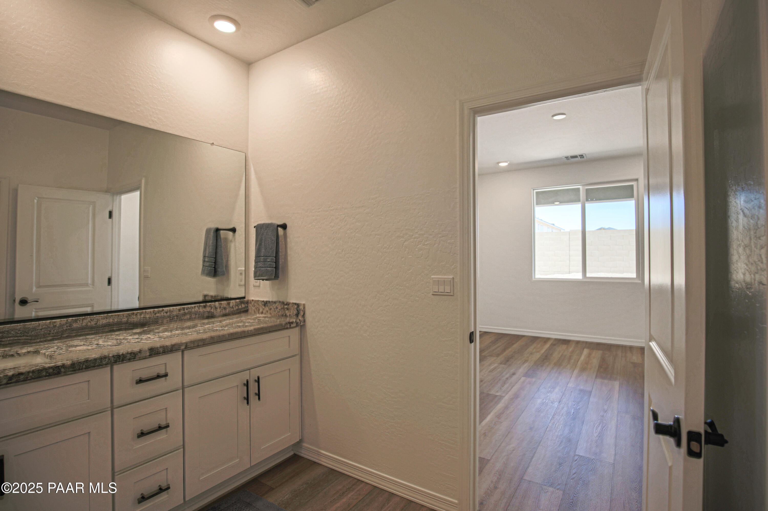 1224 Woodchute Road Prescott, AZ 86305 - Photo 25 of 43 a bathroom with a granite countertop sink mirror and vanity