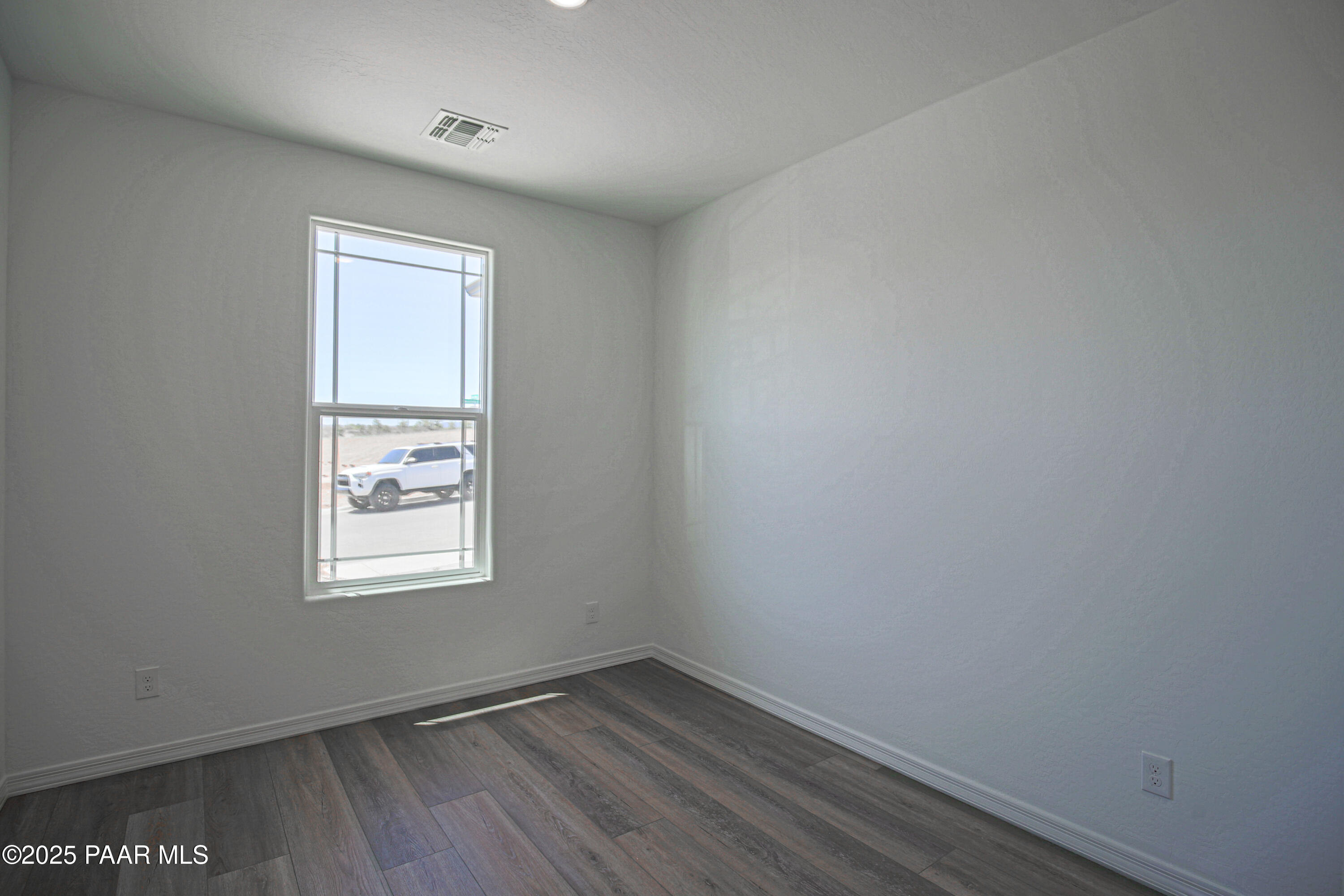 1224 Woodchute Road Prescott, AZ 86305 - Photo 28 of 43 an empty room with wooden floor and windows