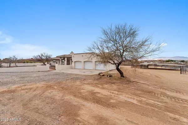 front view of a house with a large window and potted plants