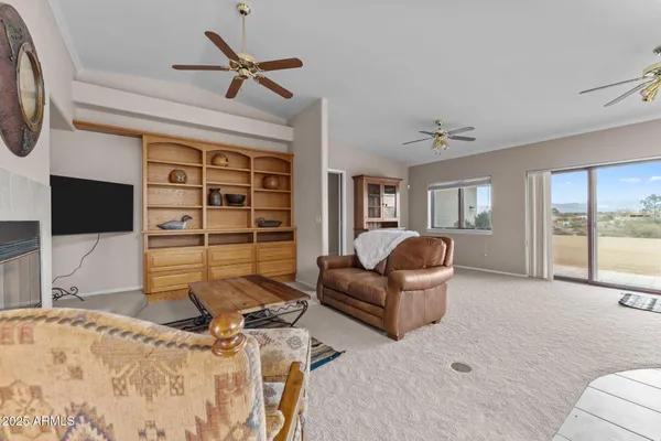 a living room with furniture a window and a fireplace