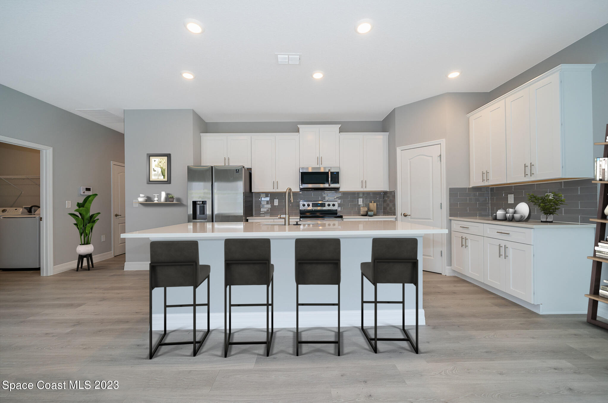 209 Tatum Road Southwest Palm Bay, FL 32908 - Photo 12 of 27 a kitchen with granite countertop a counter space dining table and stainless steel appliances