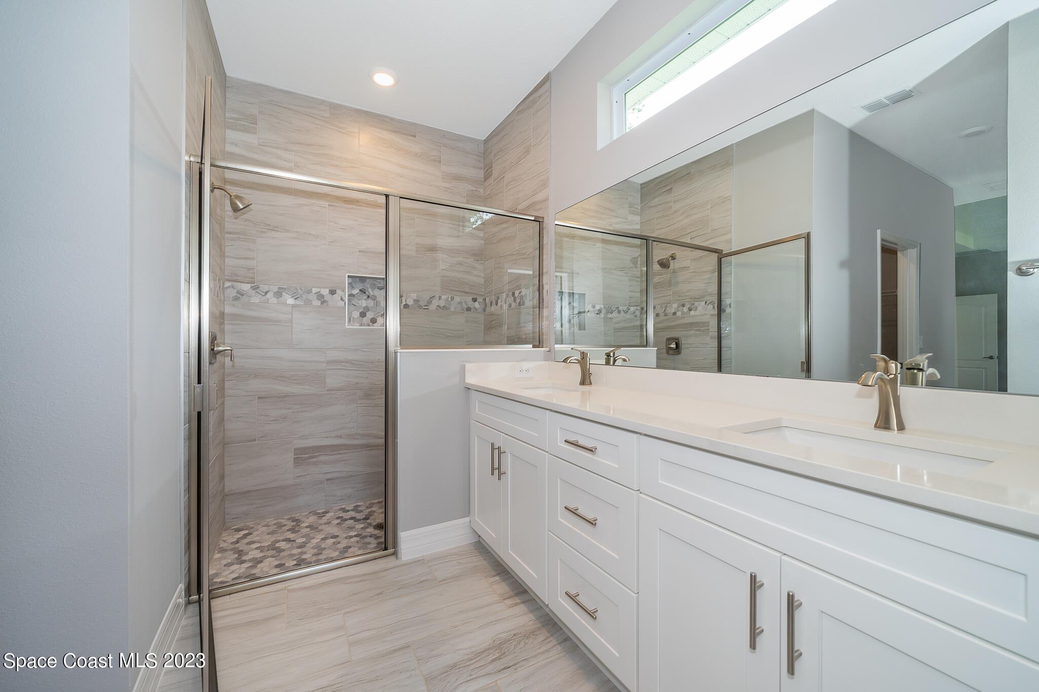 209 Tatum Road Southwest Palm Bay, FL 32908 - Photo 17 of 27 a bathroom with a double vanity sink and a mirror