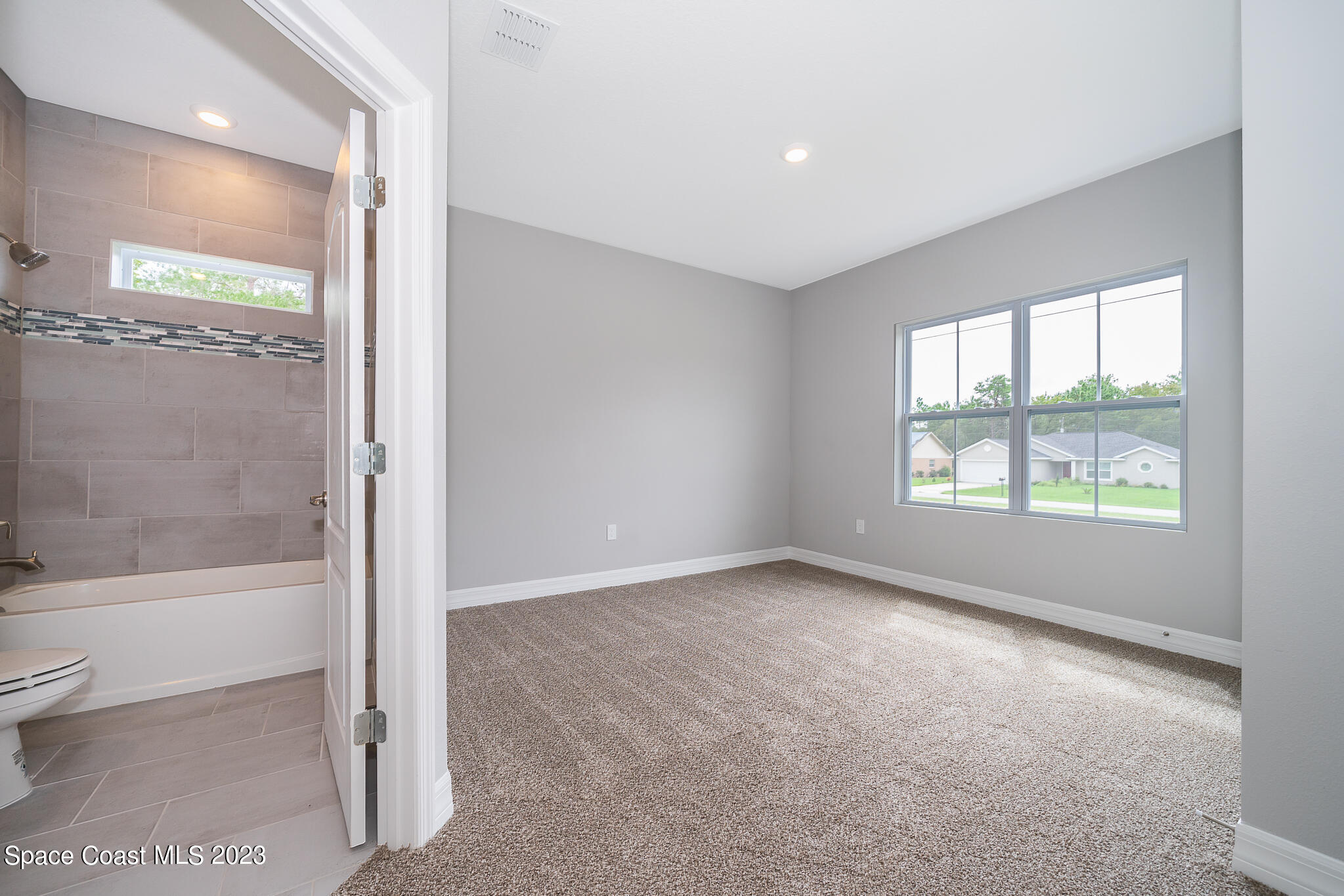 209 Tatum Road Southwest Palm Bay, FL 32908 - Photo 19 of 27 a view of an empty room with a window