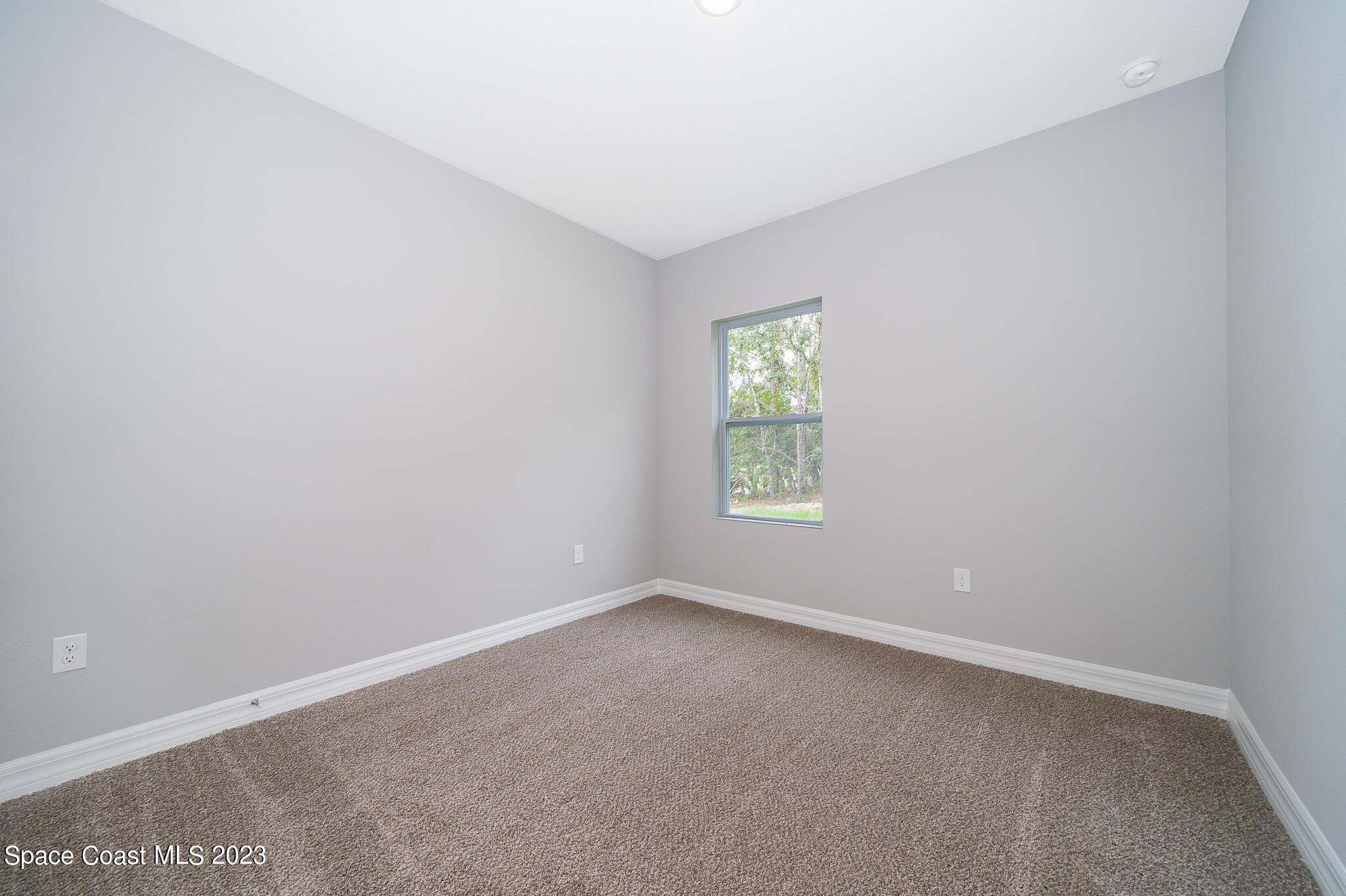 209 Tatum Road Southwest Palm Bay, FL 32908 - Photo 22 of 27 an empty room with a window