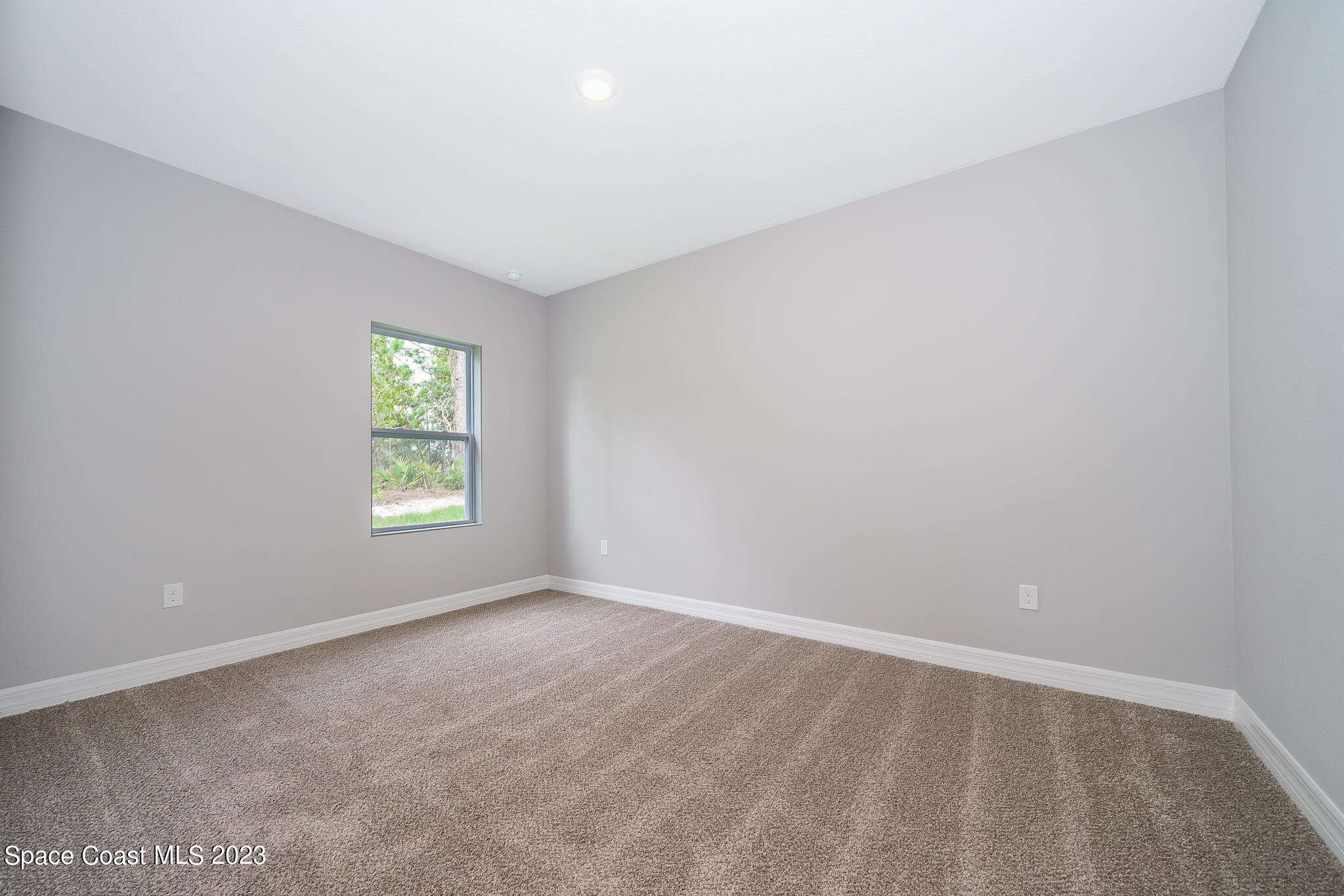 209 Tatum Road Southwest Palm Bay, FL 32908 - Photo 23 of 27 an empty room with a window