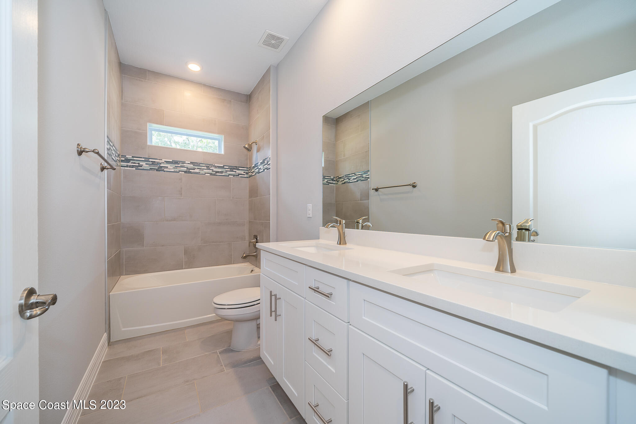 209 Tatum Road Southwest Palm Bay, FL 32908 - Photo 24 of 27 a bathroom with a granite countertop sink a toilet and shower