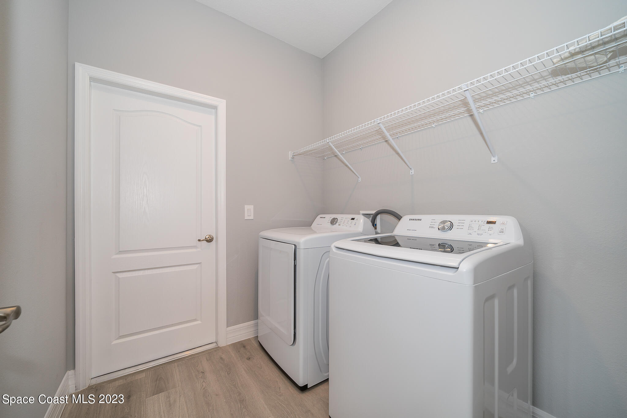 209 Tatum Road Southwest Palm Bay, FL 32908 - Photo 25 of 27 a utility room with dryer and washer