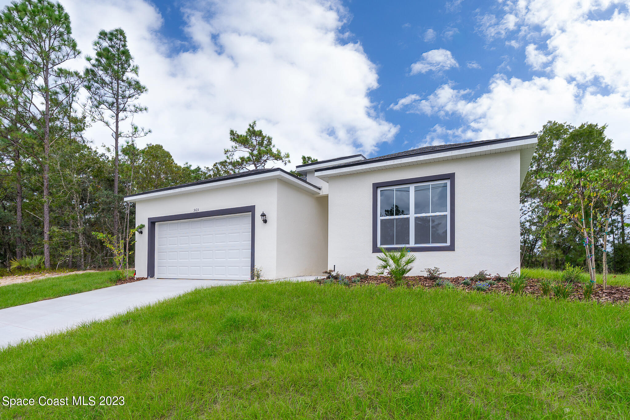 209 Tatum Road Southwest Palm Bay, FL 32908 - Photo 3 of 27 a front view of house with yard and green space