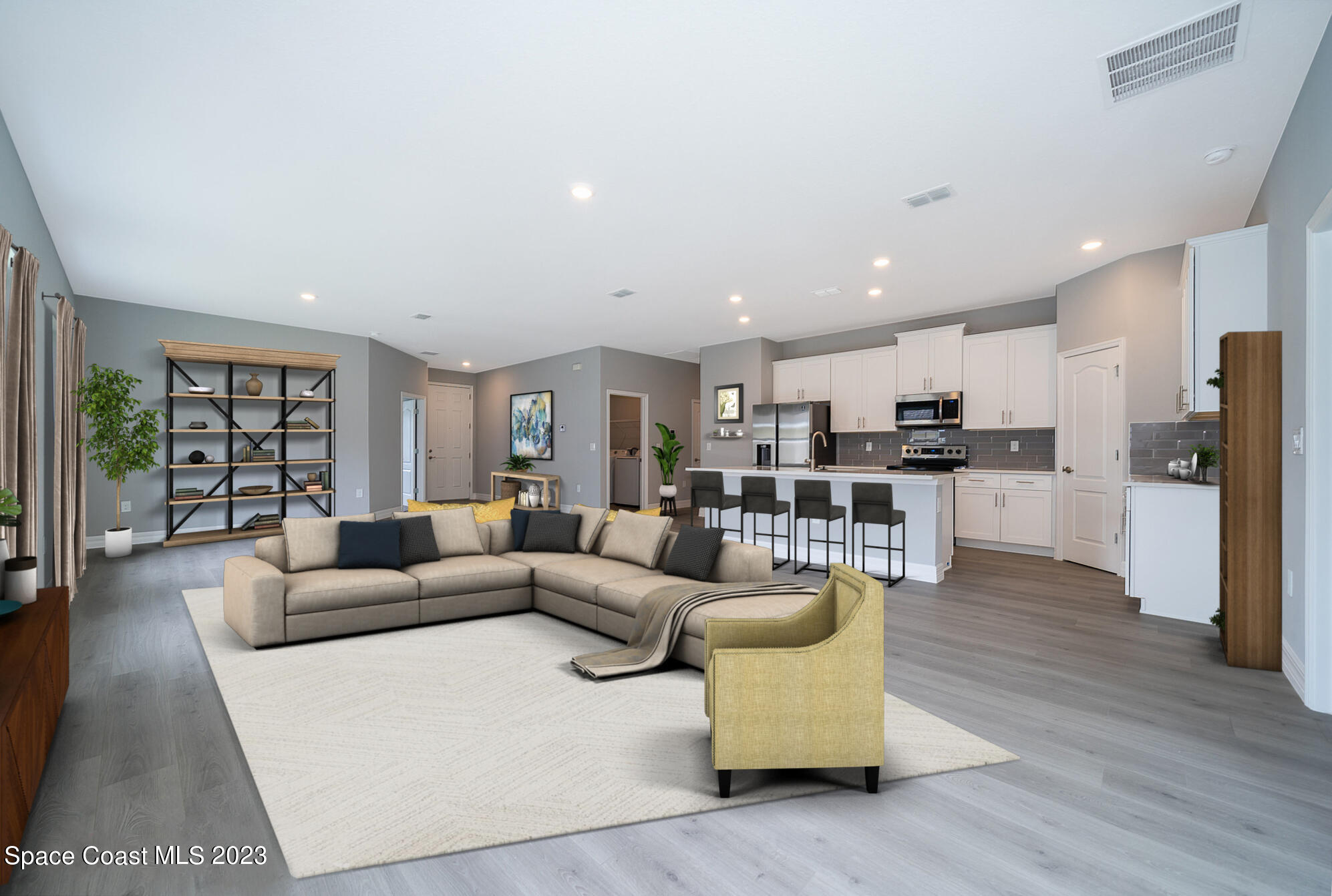 209 Tatum Road Southwest Palm Bay, FL 32908 - Photo 10 of 27 a living room with furniture wooden floor and kitchen view