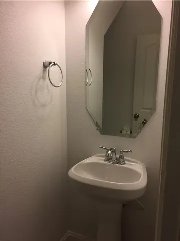 a bathroom with a sink and mirror