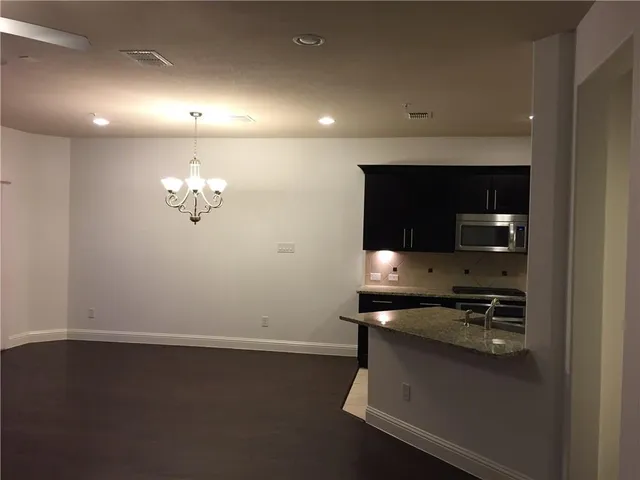 a kitchen with a sink and chandelier