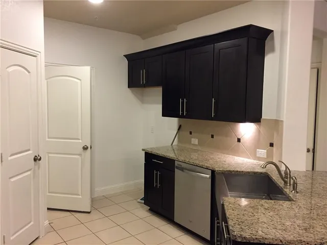 a kitchen with a sink and cabinets