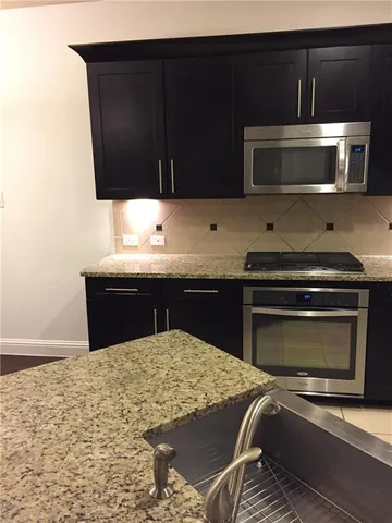 a kitchen with a sink and a microwave