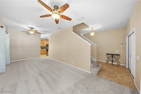 a view of an empty room and kitchen view