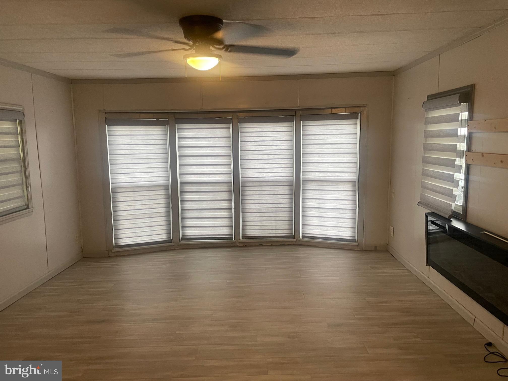 331 Tansboro Road, Unit 30 Berlin, NJ 08009 - Photo 4 of 14 an empty room with wooden floor and windows