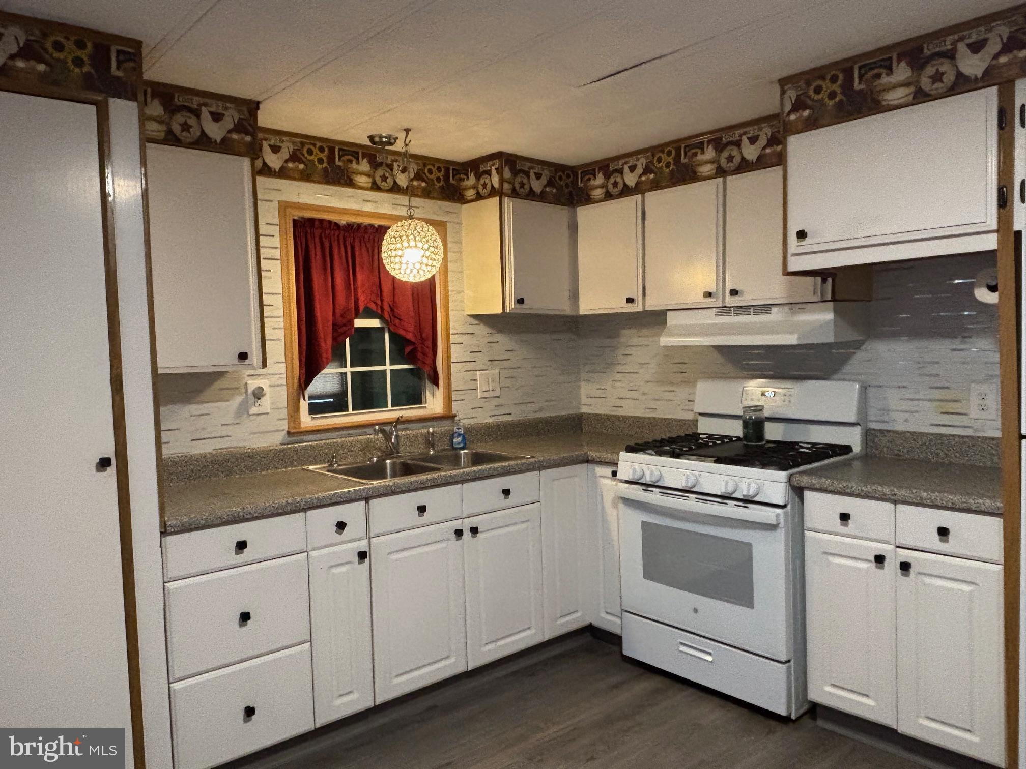 331 Tansboro Road, Unit 30 Berlin, NJ 08009 - Photo 6 of 14 a kitchen with white cabinets and white appliances