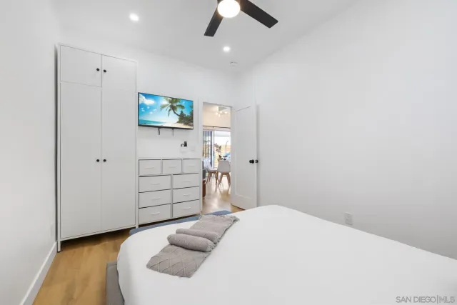 a bedroom with a bed and a ceiling fan
