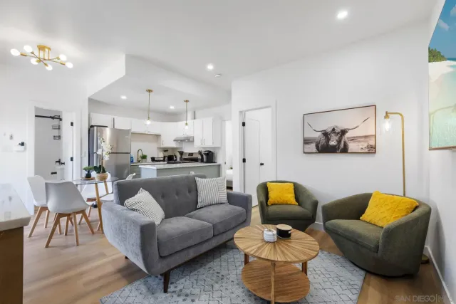 a living room with furniture and a chandelier