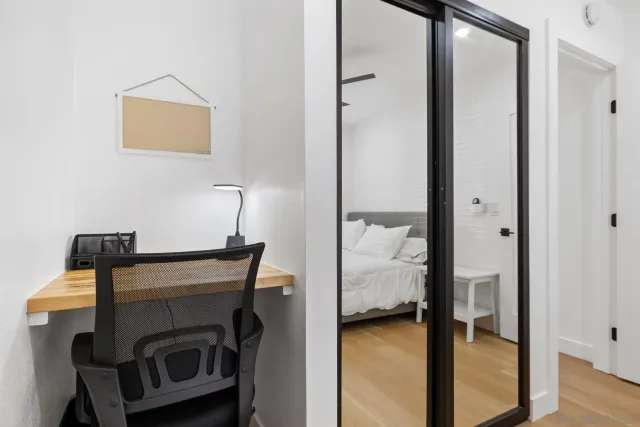 a view of hallway with livingroom and furniture